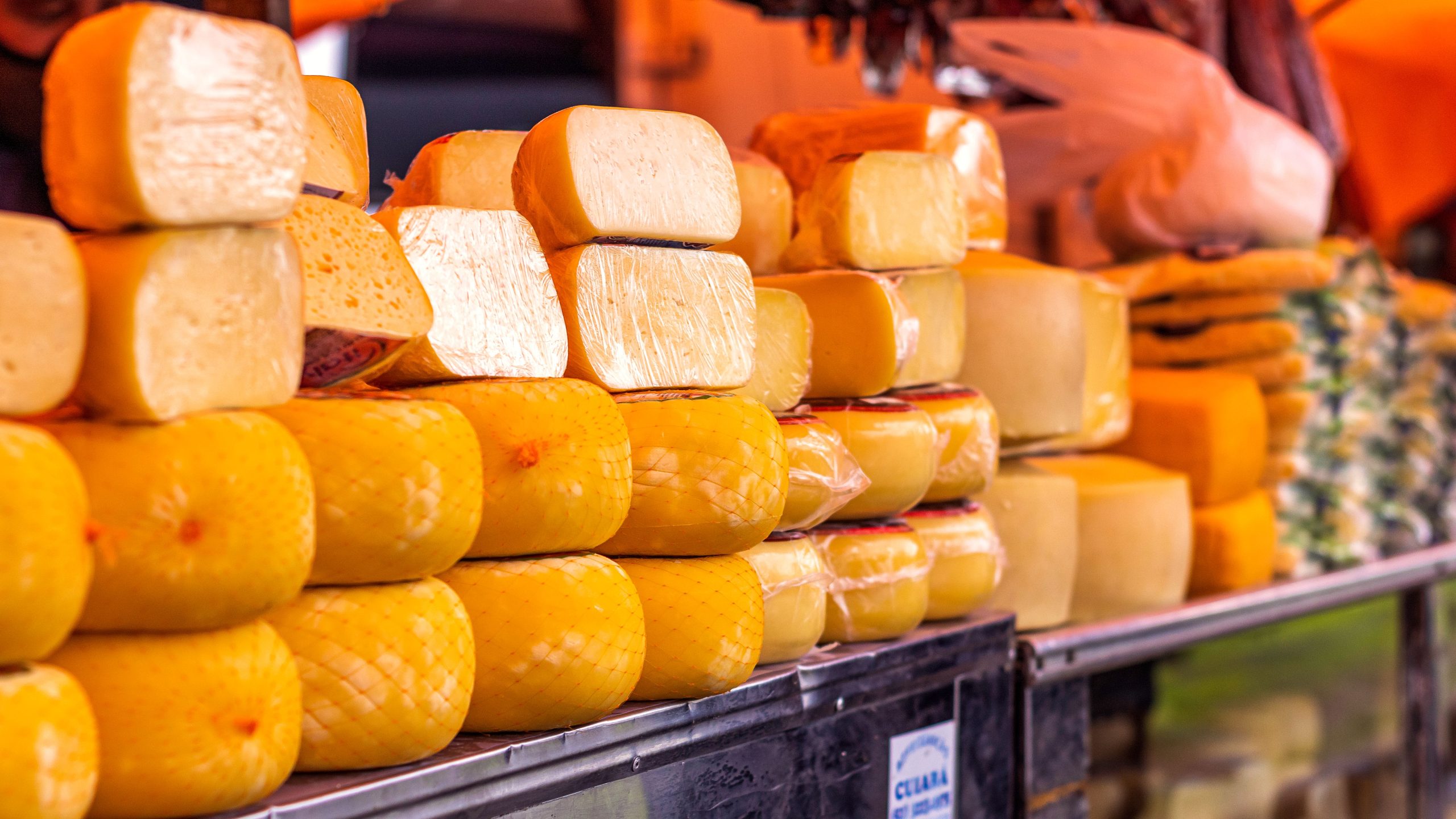 Authentic Mexican Queso Fresco and Cotija cheese displayed on a market shelf