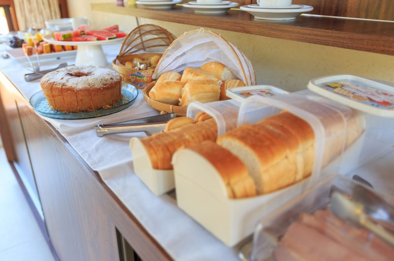 Freshly sliced unbromated white bread loaf on a wooden table