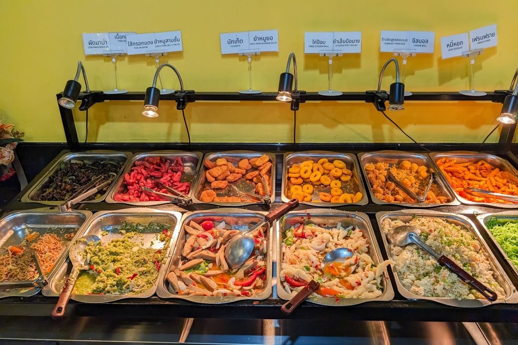 A colorful seafood and cold salad bar display at a luxury resort dining hall.