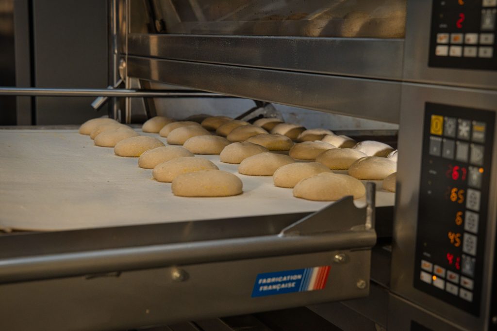 Industrial commercial bakery assembly line mass producing white sandwich bread