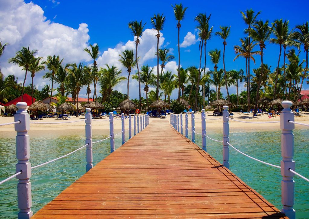 A luxury resort pool and tropical beach background in Punta Cana, Dominican Republic, showing a vacation setting.