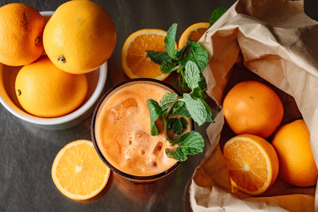 visual comparison of whole oranges versus one glass of commercial juice